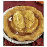 Foil pan holding a yellow molded dessert with a glossy topping