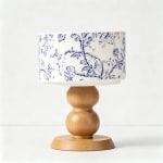 Decorative table lamp with a blue floral shade and wooden base