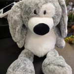 Gray and white plush dog toy with floppy ears and a black nose