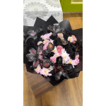 Bouquet of pink and black flowers wrapped in black paper
