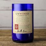 Blue glass candle jar with a vanilla bean label