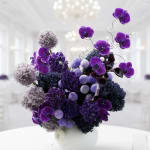Purple orchid arrangement in a white vase