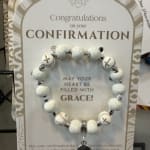 Confirmation gift card with a beaded bracelet attached