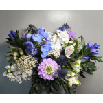 Bouquet of blue, white, and lavender flowers with dark greenery