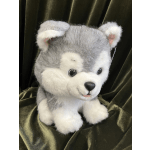 Plush gray-and-white husky teddy bear on dark fabric