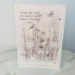 Sympathy card with a floral meadow illustration and the words "Those we love are never more than a thought away"