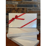 Stacked white gift boxes tied with red Valentine ribbon