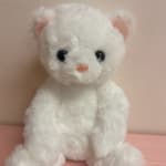 White plush teddy bear with pink ears and nose