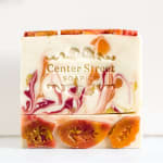 Decorative soap bar with marbled red, orange, and white patterns
