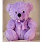 Lavender plush teddy bear with a satin bow sitting against a neutral background.