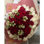 Bouquet of red and white roses wrapped in pink paper