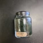 Glass jar candle labeled Balsam & Cedar