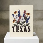 Decorative sign with wildflowers above the word TEXAS