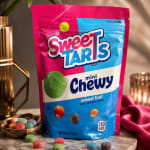 Bag of SweetTarts mini chewy candy on a table with loose candies