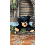 Black teddy bear sitting in a rustic twig wreath