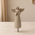 Decorative angel figurine with outstretched wings on a stand