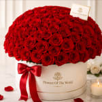 Large red rose arrangement in a white hat box with a red ribbon