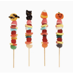 Four Halloween candy skewers with pumpkin, cat, and candy corn toppers