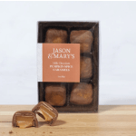 Box of pumpkin spice caramels with two cut pieces in front