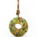 Colorful glass ring ornament hanging from a rope