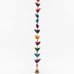 Colorful hanging bird garland with a small brass bell