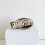 Bundle of dried sage wrapped in a shell dish