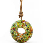 Colorful glass ring ornament hanging from a rope cord
