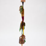 Hanging multicolored fabric tassel with a copper bell