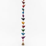 Colorful hanging bird garland with a small brass bell
