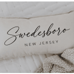 Cream pillow with the word "Swedesboro" printed on it