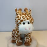 Plush giraffe toy with brown-and-white spots and a white snout