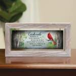 Framed cardinal memorial sign on a tabletop