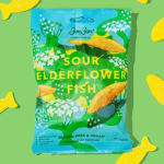 Bag of Sour Elderflower Fish candy on a green background