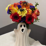 Halloween bouquet in a ghost-shaped vase with spider decorations