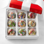 Box of colorful decorated chocolates in a red gift box