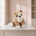 Plush bulldog toy sitting on a white table in a pastel room