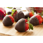 Chocolate-dipped strawberries on a wooden board with a red rose in the background