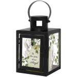 Black metal lantern with glass panels featuring white doves and the words "In the arms of an Angel."