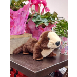 Potted cyclamen and succulents with a plush otter on a table