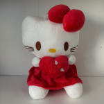 Hello Kitty plush holding a red heart, wearing a red dress