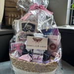 Gift basket with assorted packaged treats and bath items in clear wrap