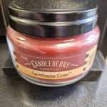 A jar candle labeled Farmhouse Cider from The Candleberry Company