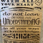 Wooden sign with cutout quote text and decorative heart accents