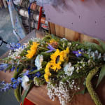 Mixed bouquet with sunflowers, blue flowers, and white filler flowers