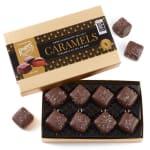 Box of dark chocolate sea salt caramels with pieces outside the box