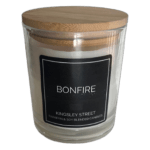 Glass candle jar with a wooden lid and black label