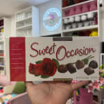 Box of assorted chocolates with red roses on the front