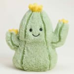Plush cactus toy with a smiling face and yellow flower accents