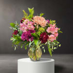 Mixed pink and purple flowers in a clear glass vase