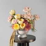 Pastel bouquet of roses and mums in a white vase